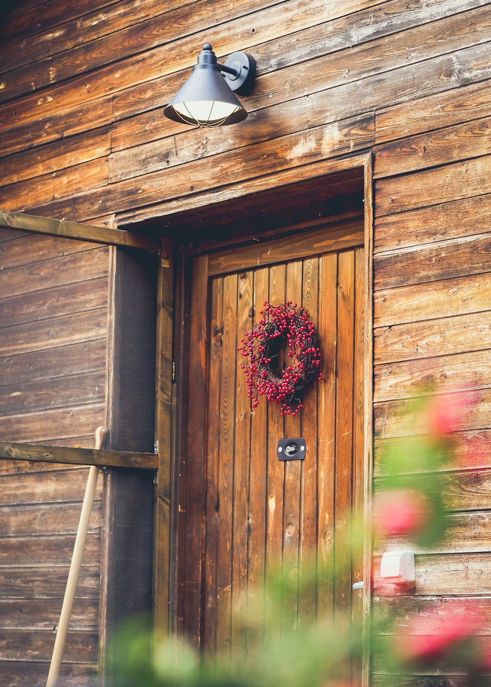 closed brown wooden door with wreath