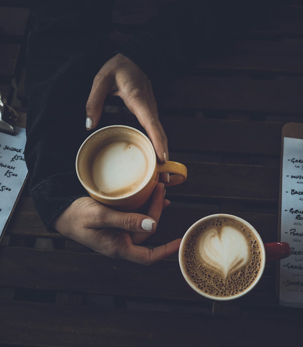 person holding ceramic mug