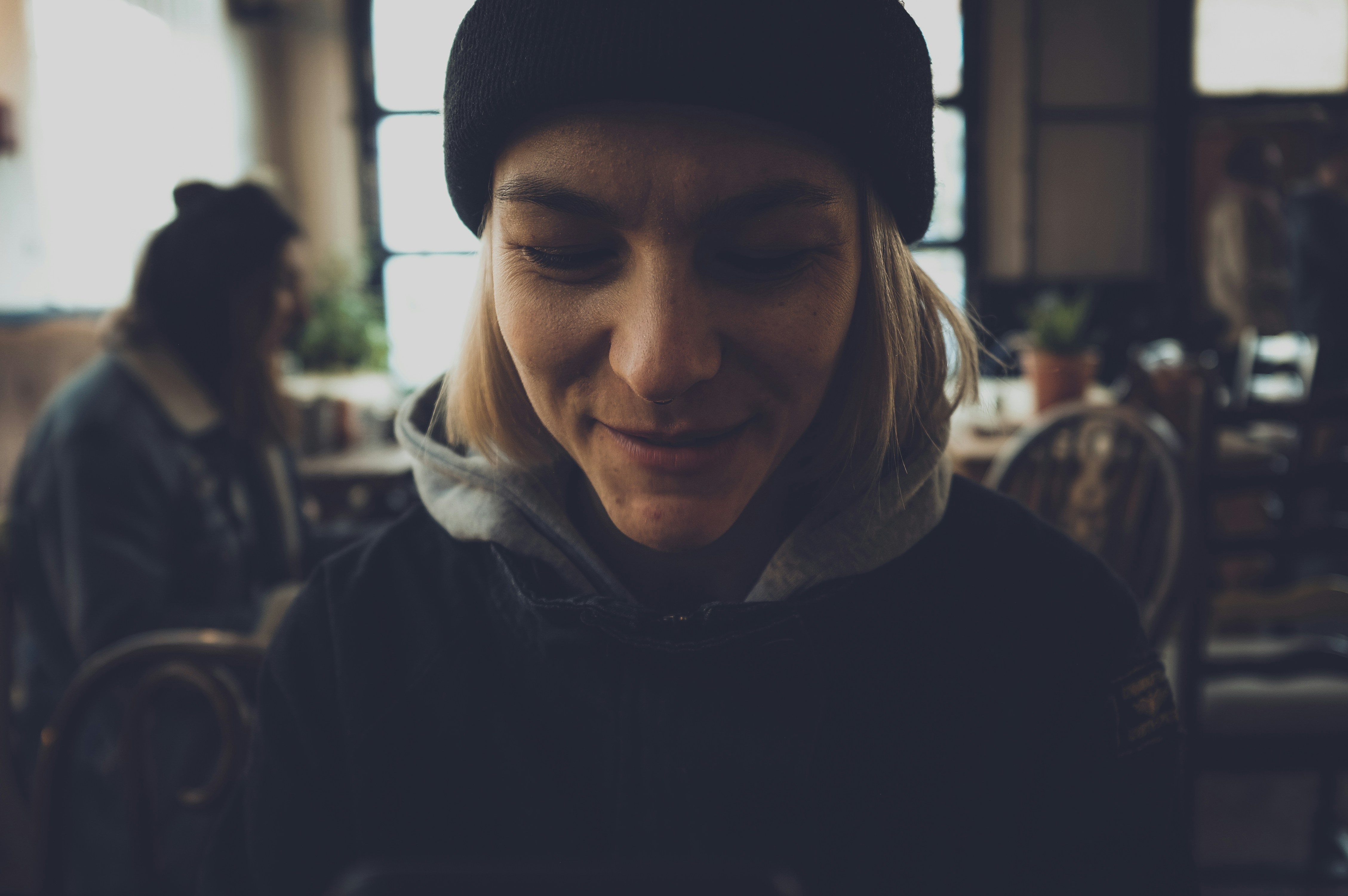 woman in black jacket and beanie cap