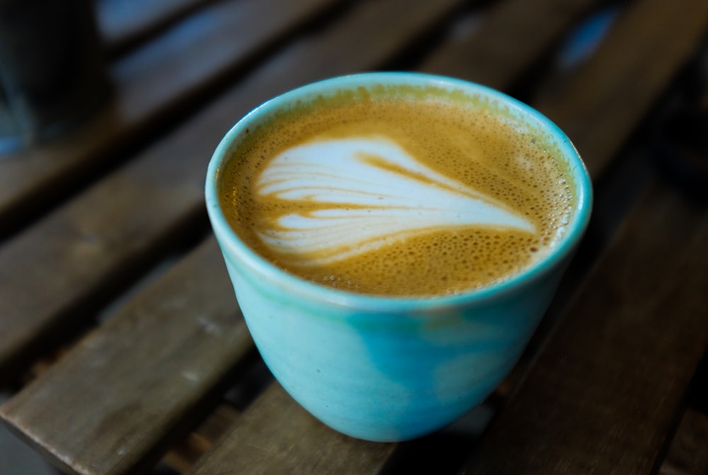 blue mug on wooden surface