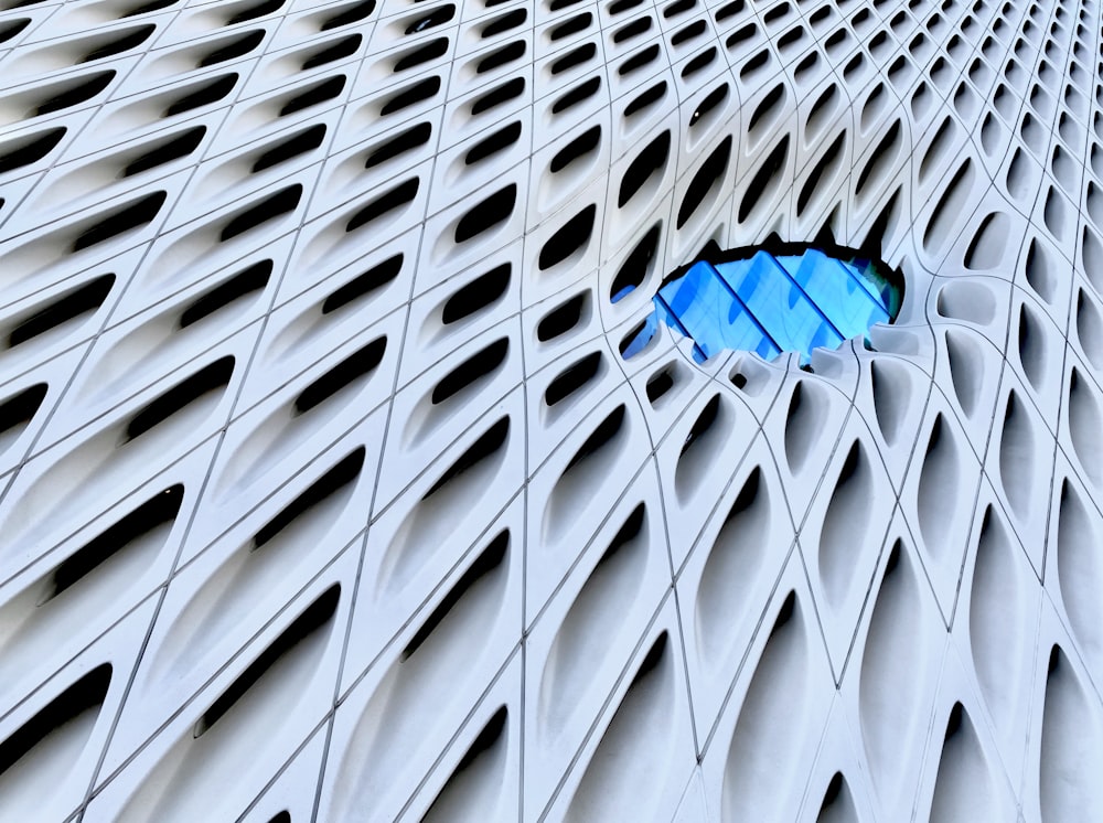 a close up of a building with a blue umbrella