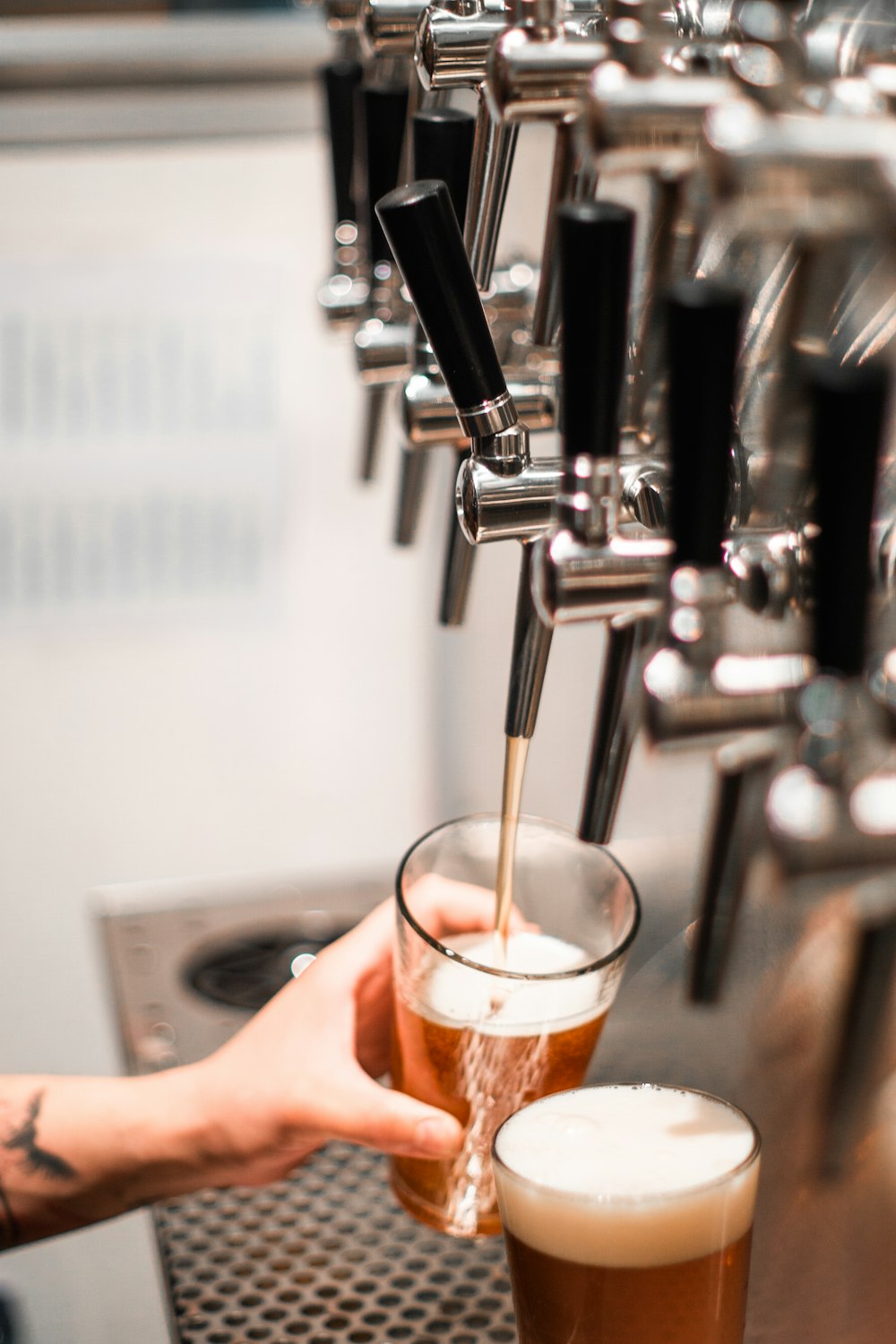 selective focus photo of beer dispenser