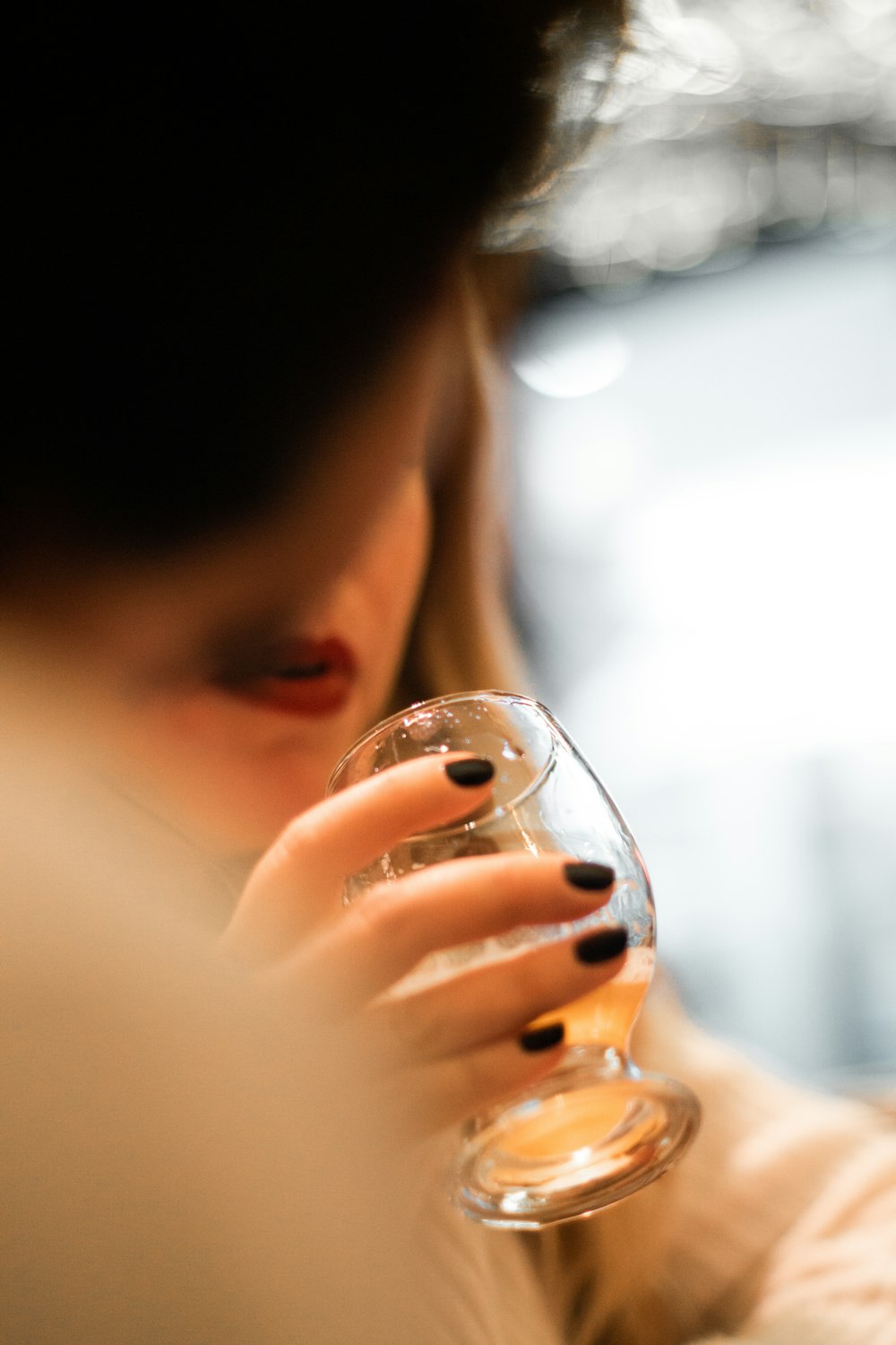 Mujer sosteniendo una taza de vidrio