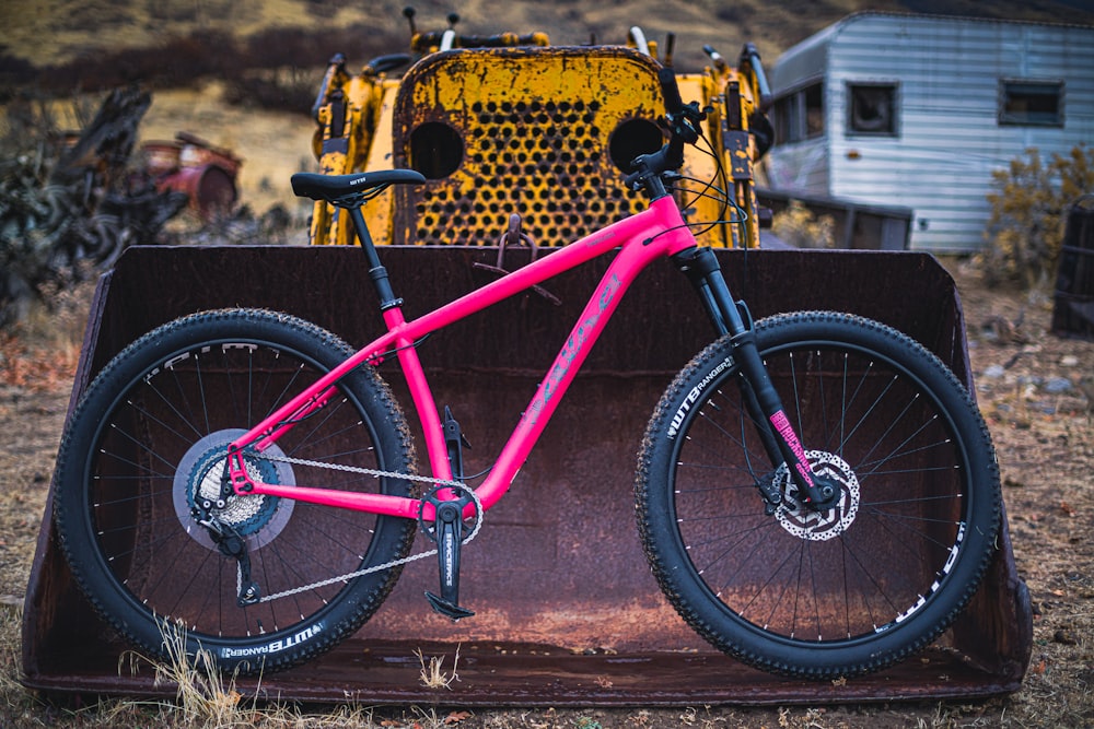 pink hardtail bike on bulldozer