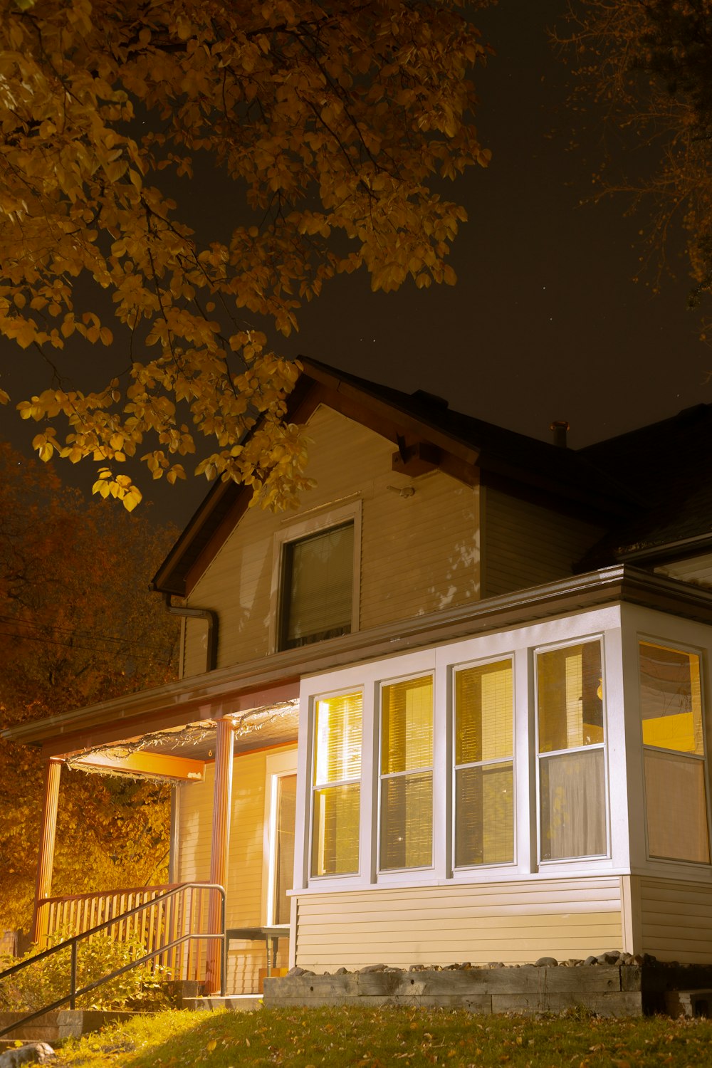 white and brown 2-storey house near tree