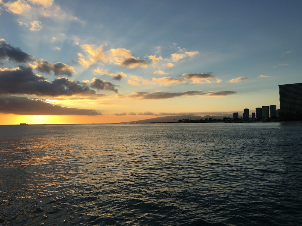 calm body of water during golden hour