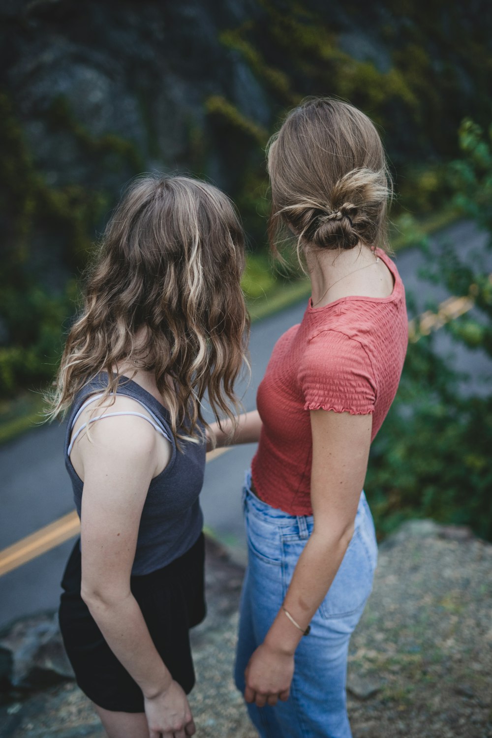 two women standing on cliff