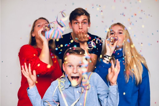 people blowing party favors