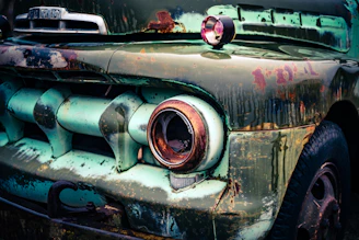 Close-up of a weathered food truck with visible rust spots and dents on the side panel.