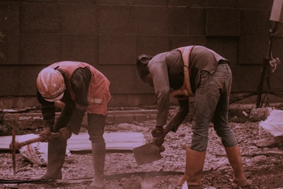 two person on brown field