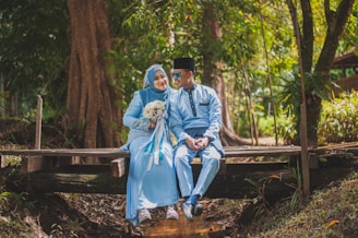 man sitting beside woman
