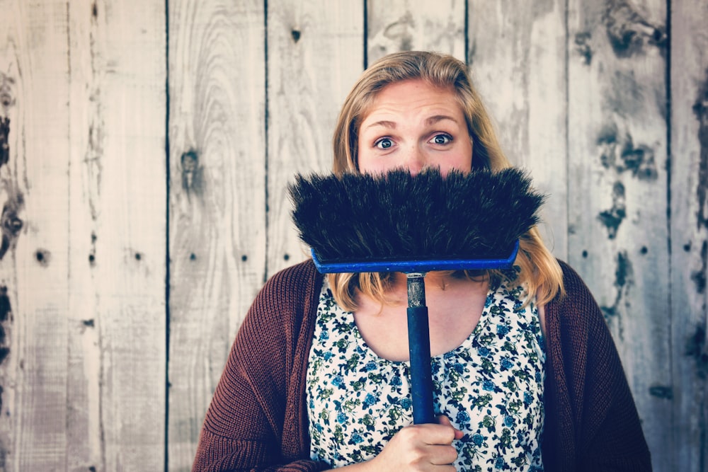 woman holding broom