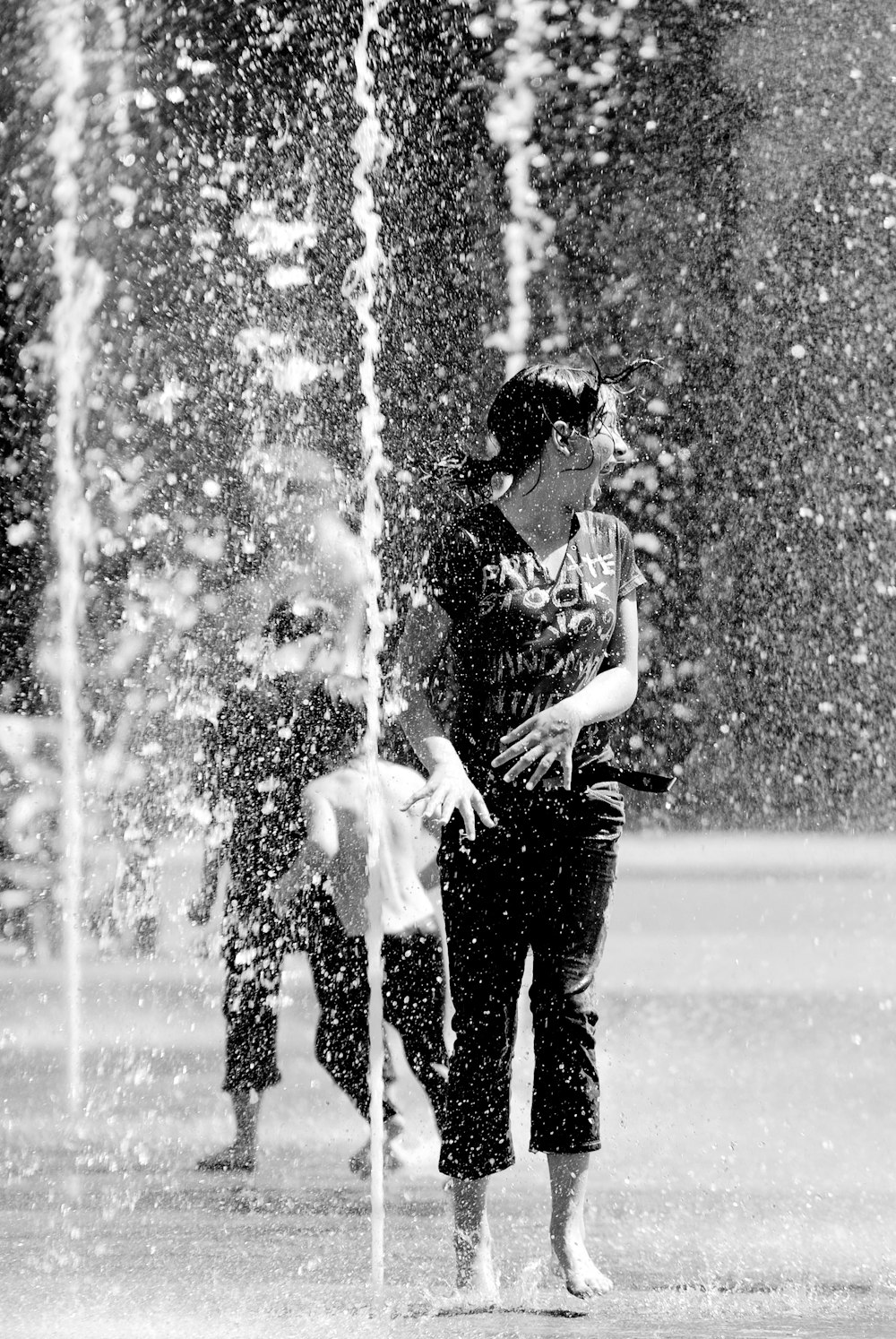 woman standing beside fountain