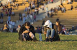 Parents and players checking schedules on their phones at the field