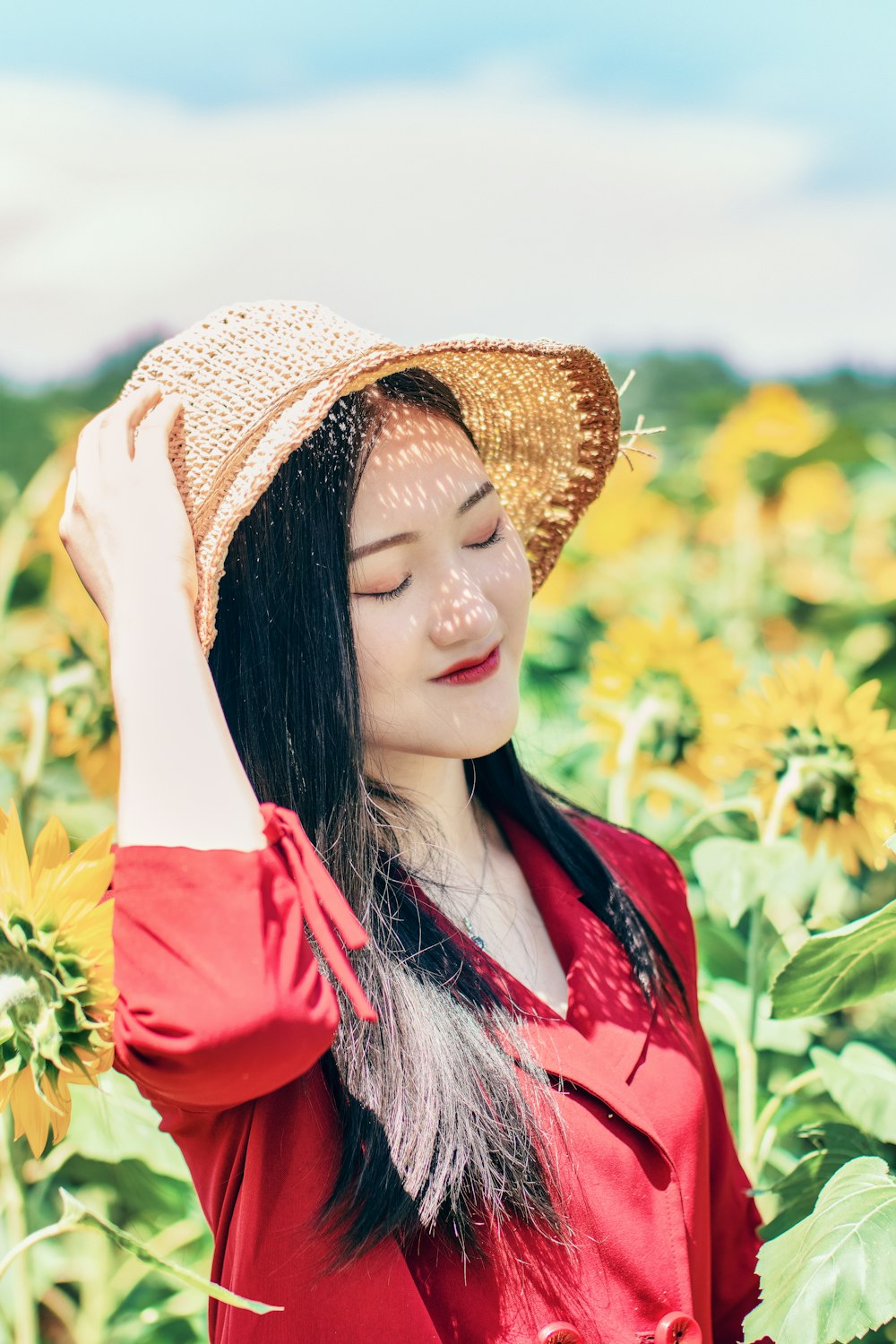 woman standing on sunflower field