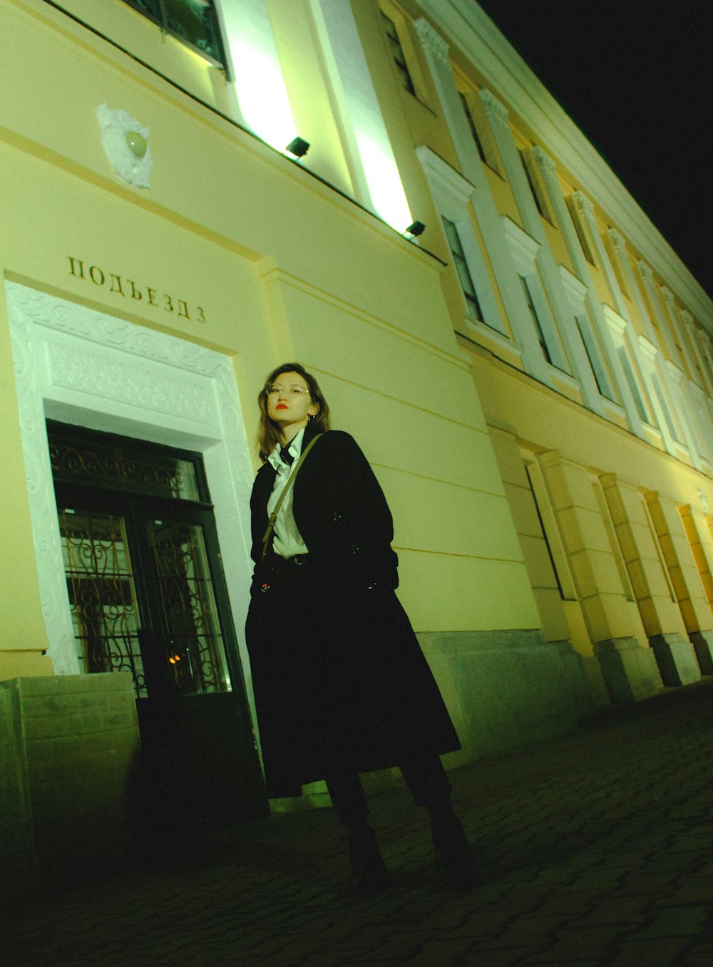 woman standing beside building