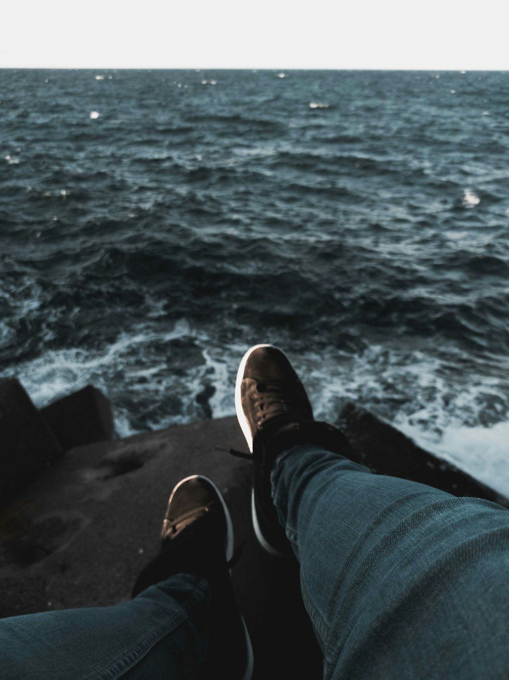 person sitting on rock