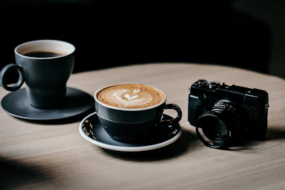 A cozy café scene with steaming cups of coffee and a camera set up for a food photography session.