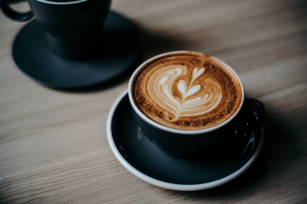 black ceramic cup and saucer