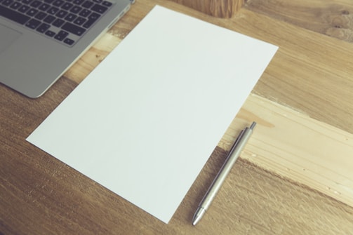 A serene desk with a notepad and pen, symbolizing inspiration.