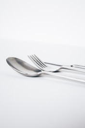 Close-up of finely crafted silverware reflecting soft light.