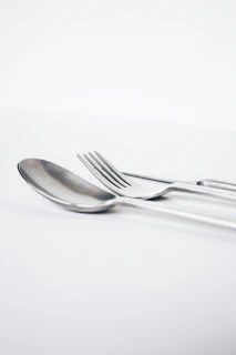 A happy customer using the silverware clip at a beautifully set dining table with soft natural light.