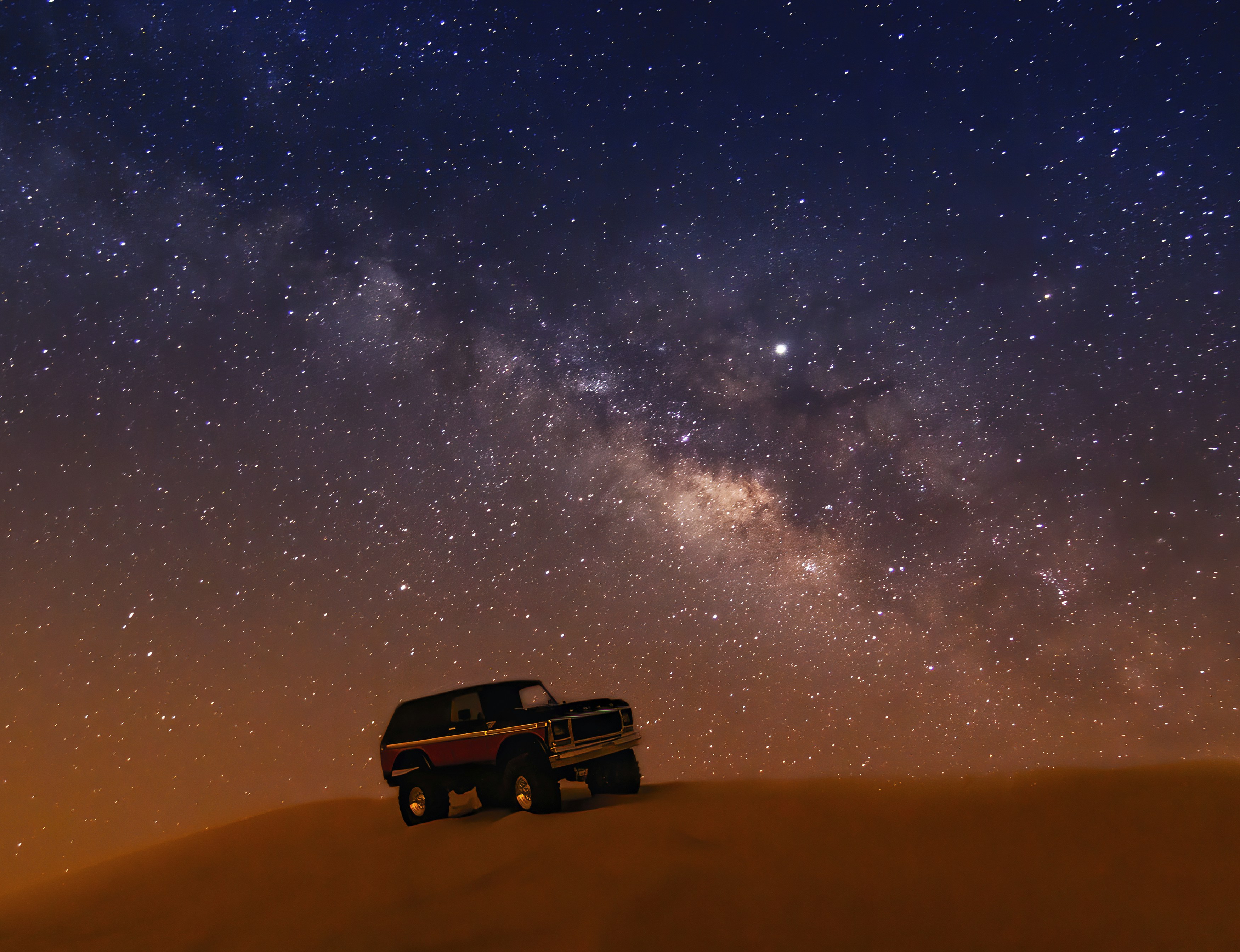 SUV on desert at night