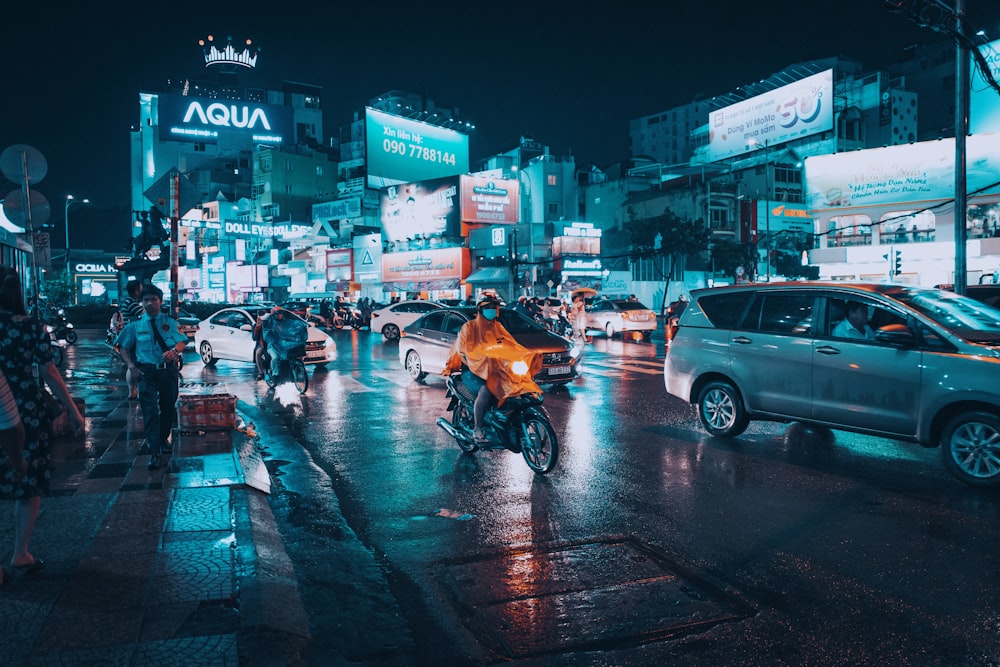 person riding on motorcycle on road at night