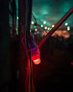 Close-up of a blue Arduino board with glowing LED lights in a dark room