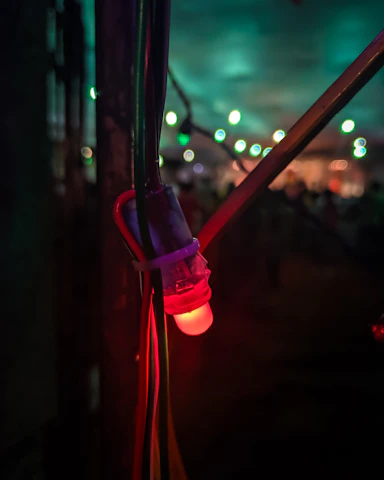 Close-up of nerve conduction study equipment with glowing electrodes.