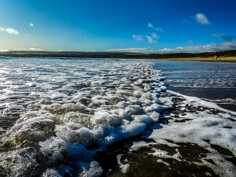 body of water under blue sky