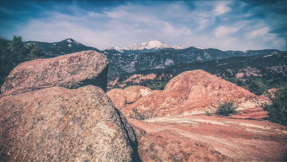 photography of rock formation and mountain range during daytime