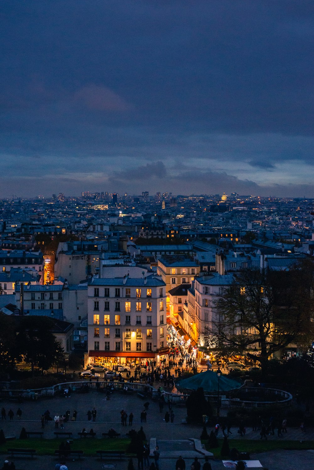 a view of a city at night from the top of a hill