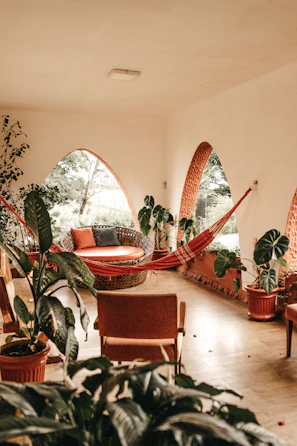 Cozy nook with a hammock chair and tropical decor accents in soft natural light.