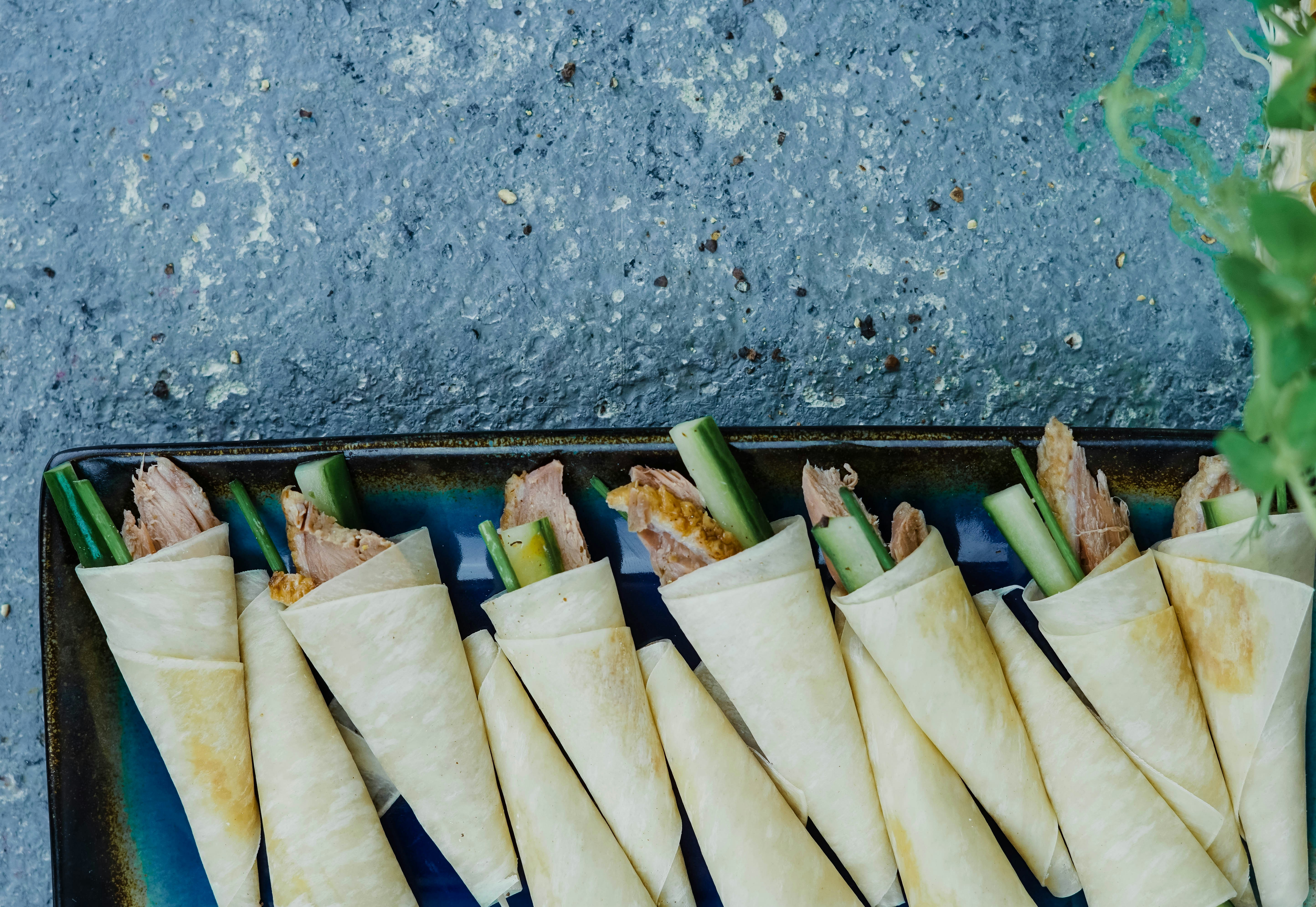 Rolled wraps on a black tray