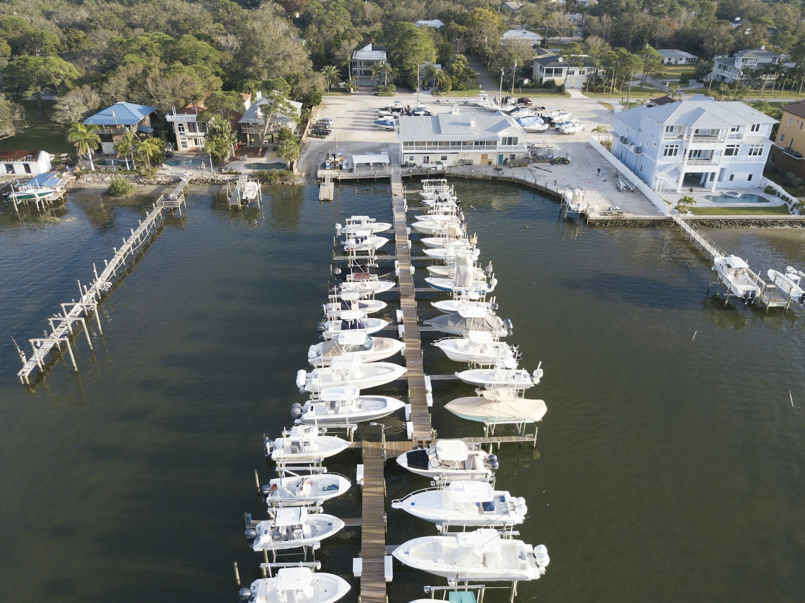 Aerial view of white motorboats on calm body of water.