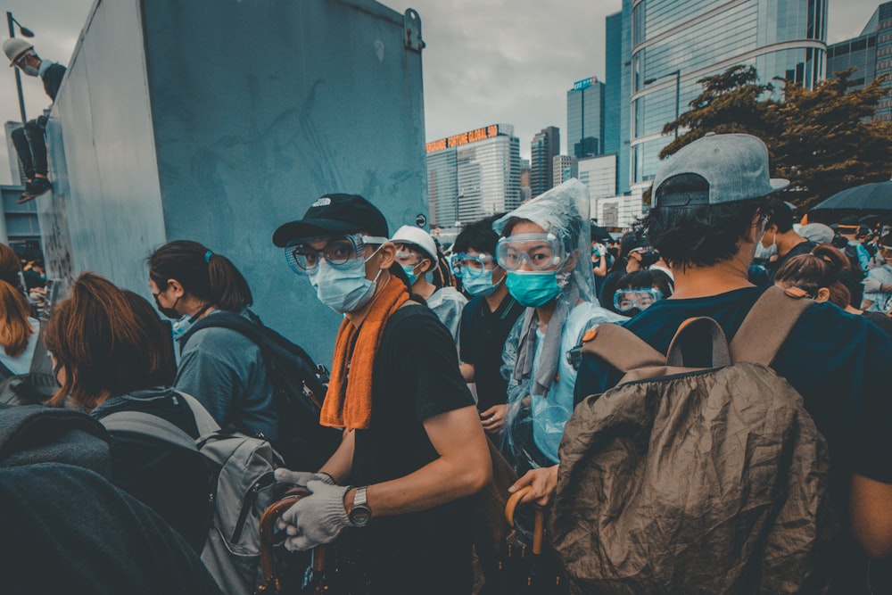 crowd of people wearing mask in the street