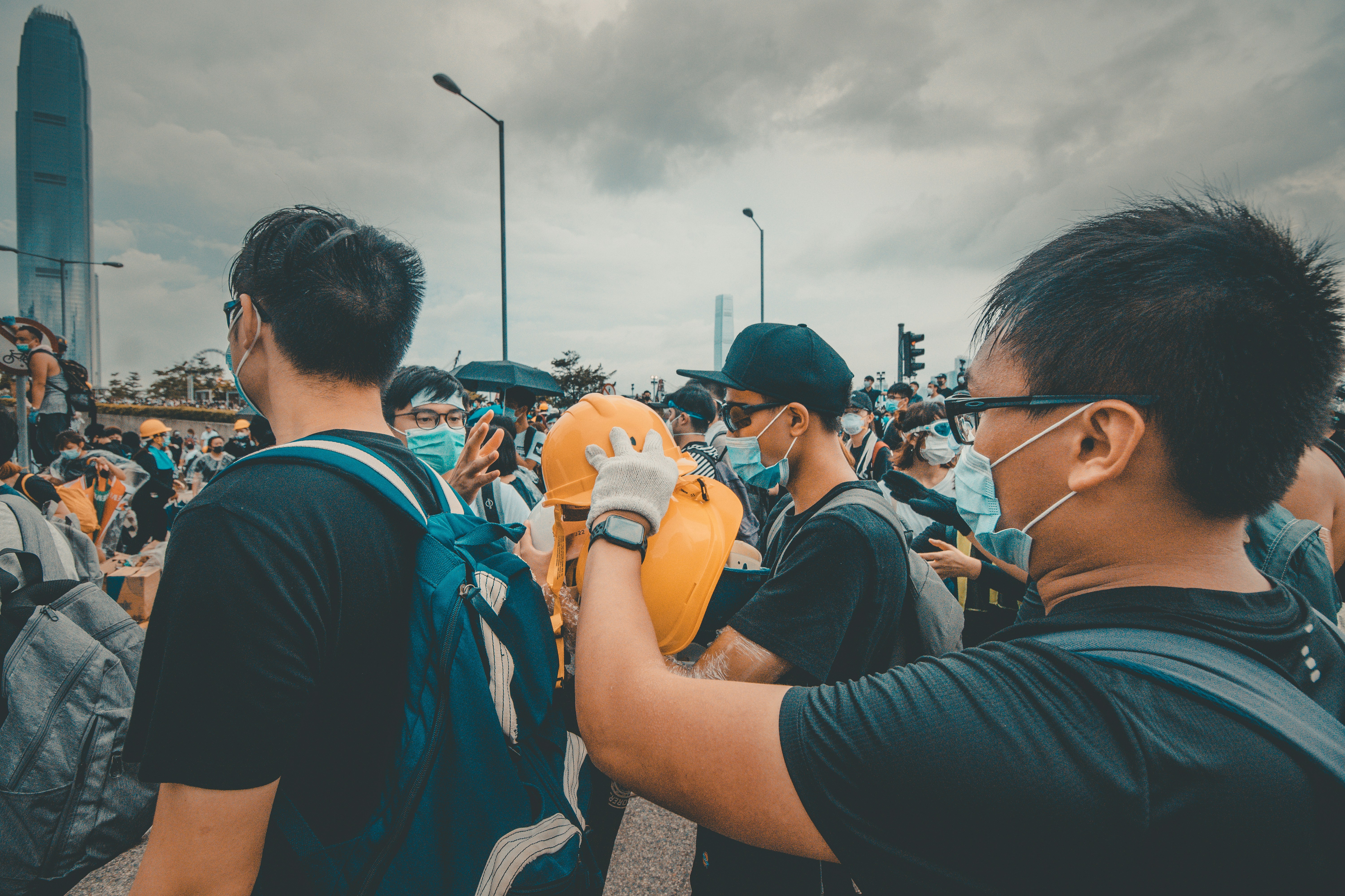 man gathered around holding yellow helmet