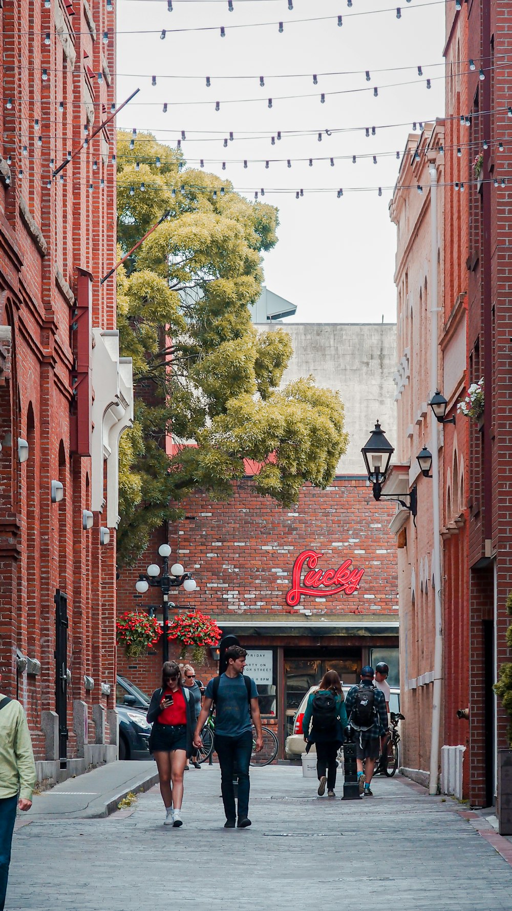 man and woman walking between building during daytime