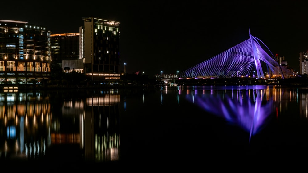 reflection of city lights on body of water during nighttime