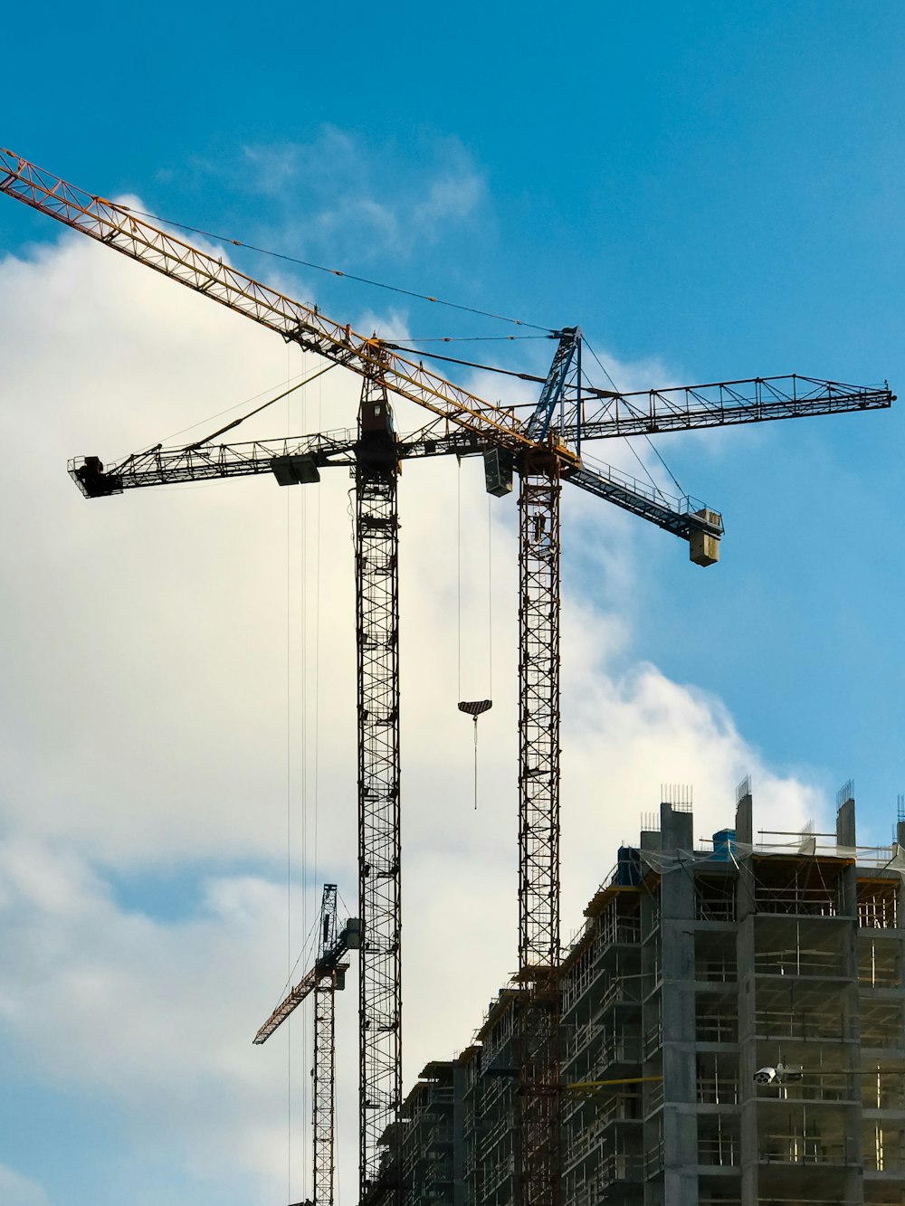 brown metal industrial crane under white and blue sky