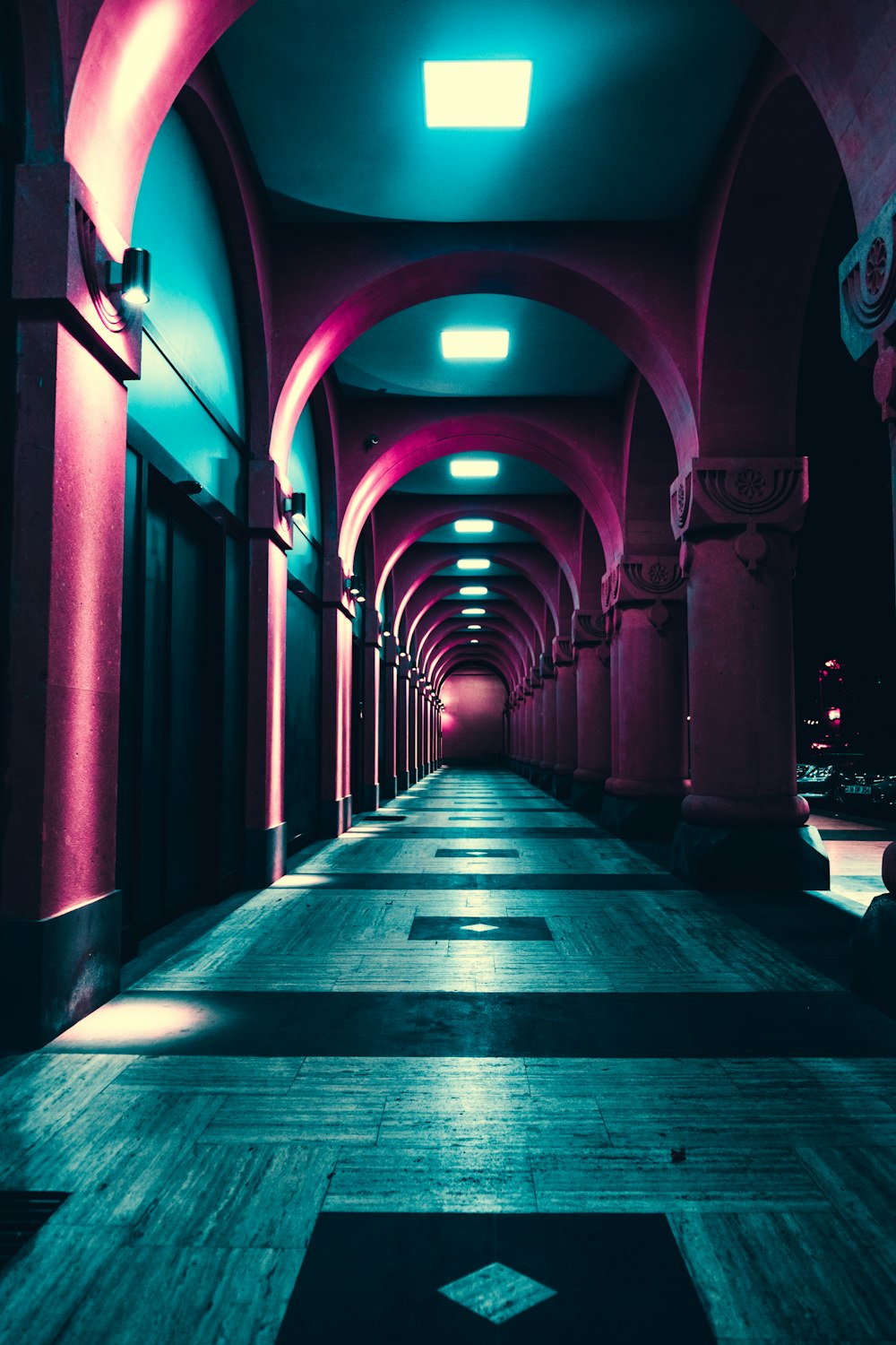 a very long hallway with some lights on