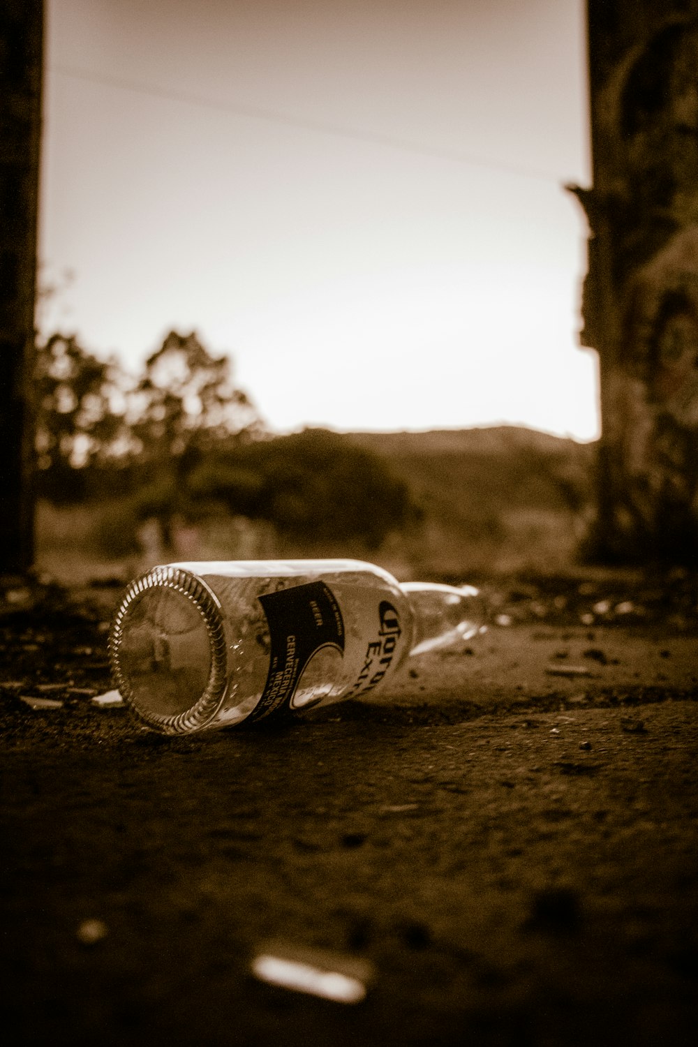 a bottle that is sitting on the ground