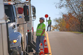 man standing beside parked truck