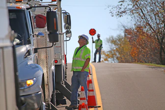 man standing beside parked truck