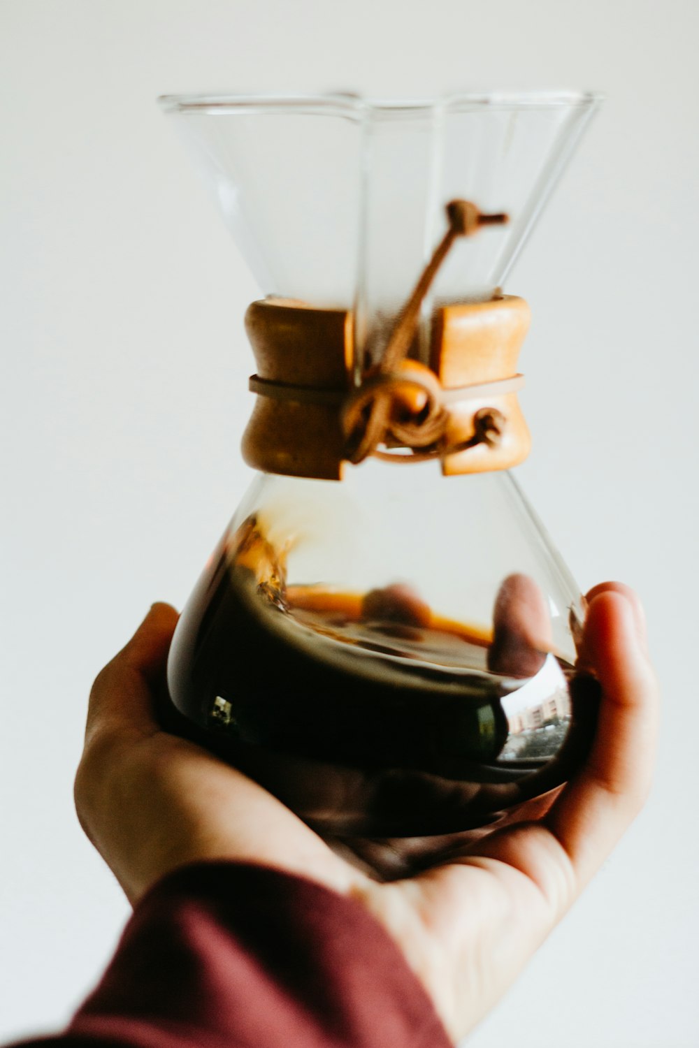 person holding jar with liquid