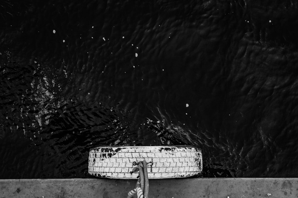 a black and white photo of a rope on a wall