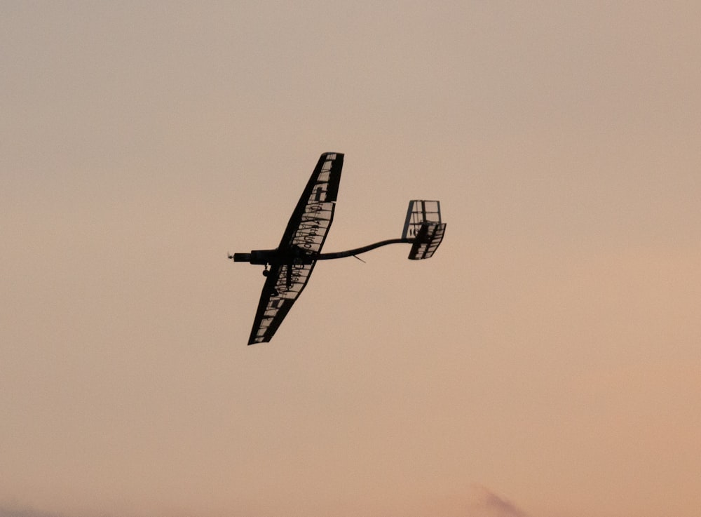 a small airplane flying through a cloudy sky