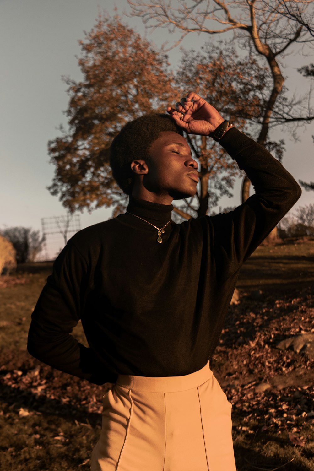 selective focus photography of standing man with eyes close during daytime