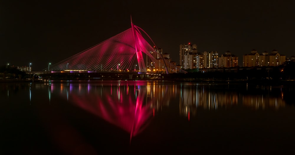 reflection of building on body of water at night